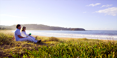 A couple at Reflections Barlings Beach taking in the beachside view